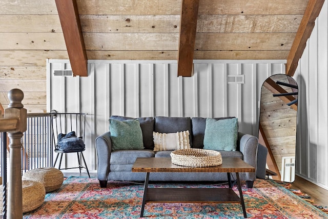 sitting room featuring wood walls and wooden ceiling