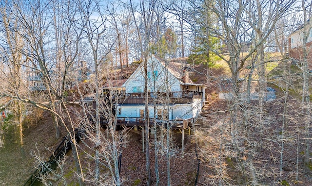 rear view of property with a wooden deck