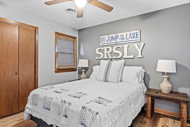 bedroom featuring hardwood / wood-style floors, ceiling fan, and a closet