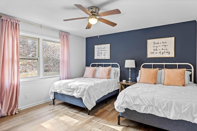 bedroom with hardwood / wood-style flooring and ceiling fan