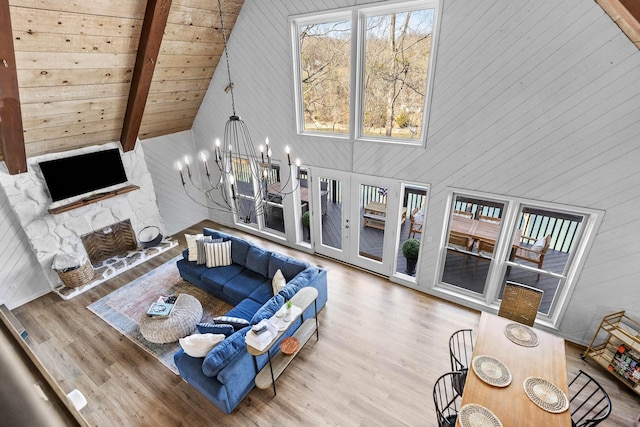 living room with beam ceiling, high vaulted ceiling, and wood-type flooring