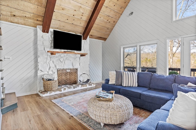 living room featuring a fireplace, high vaulted ceiling, wooden ceiling, beamed ceiling, and hardwood / wood-style floors