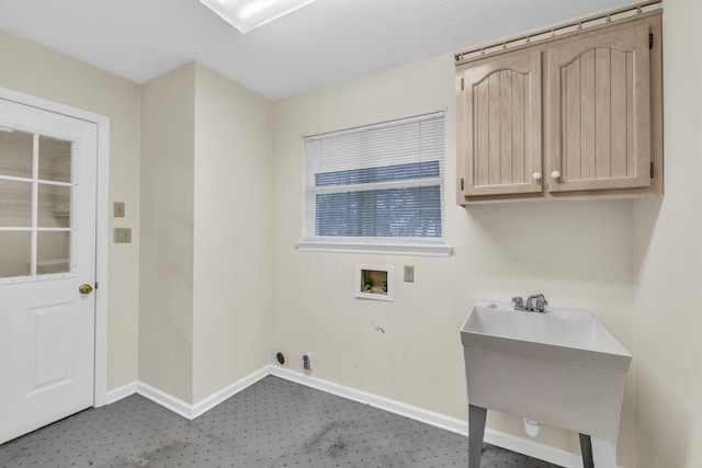 clothes washing area featuring cabinets, sink, and hookup for a washing machine