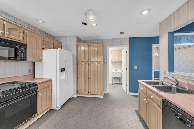 kitchen featuring light brown cabinetry, sink, and black appliances