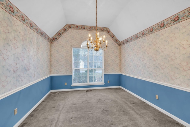 empty room featuring carpet flooring, vaulted ceiling, and a notable chandelier