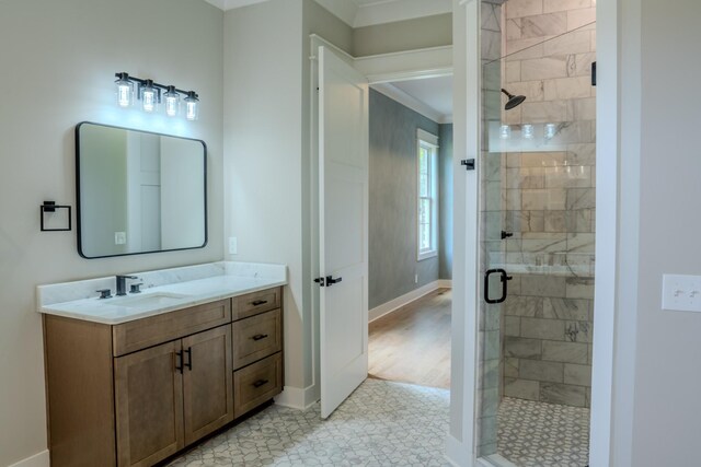 bathroom featuring vanity, an enclosed shower, and crown molding