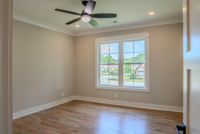 unfurnished room with ceiling fan, light hardwood / wood-style flooring, and ornamental molding