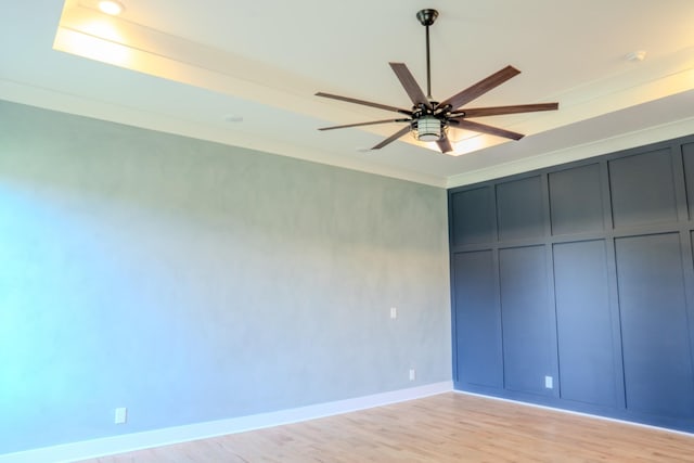 unfurnished bedroom with ceiling fan, crown molding, and light hardwood / wood-style flooring