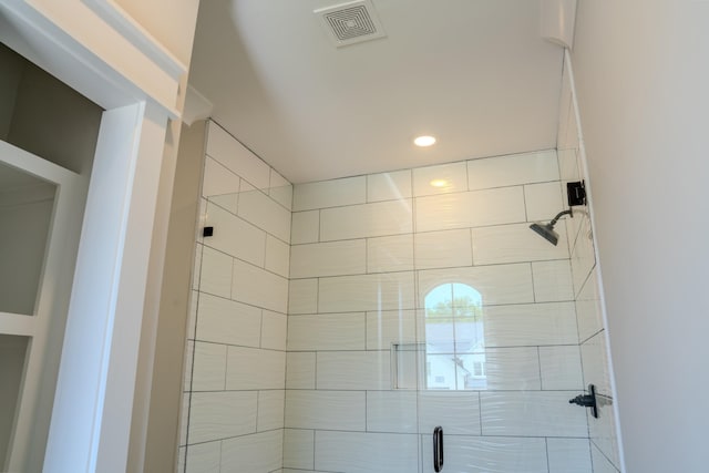 bathroom with a shower with door