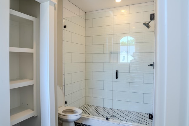 bathroom featuring built in features, toilet, and walk in shower