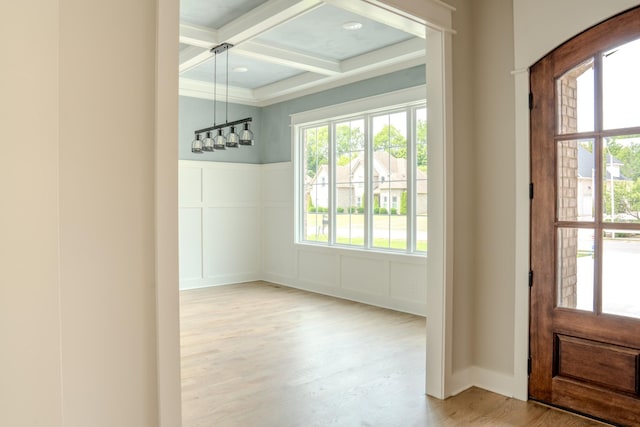 foyer entrance featuring hardwood / wood-style floors, coffered ceiling, and beam ceiling