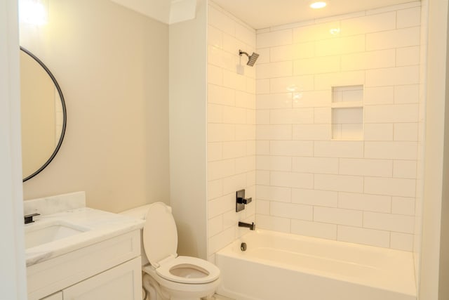 full bathroom with vanity, tiled shower / bath combo, and toilet