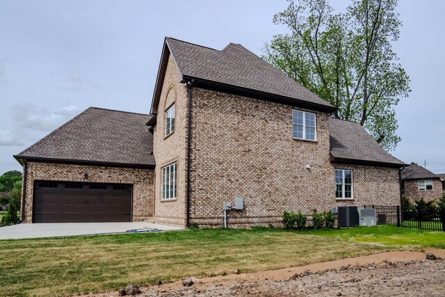 view of property exterior with a lawn, cooling unit, and a garage