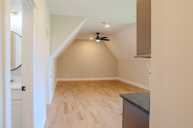 bonus room with ceiling fan, lofted ceiling, and light wood-type flooring