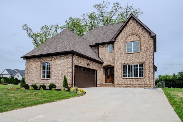 view of front of house featuring a garage and a front lawn