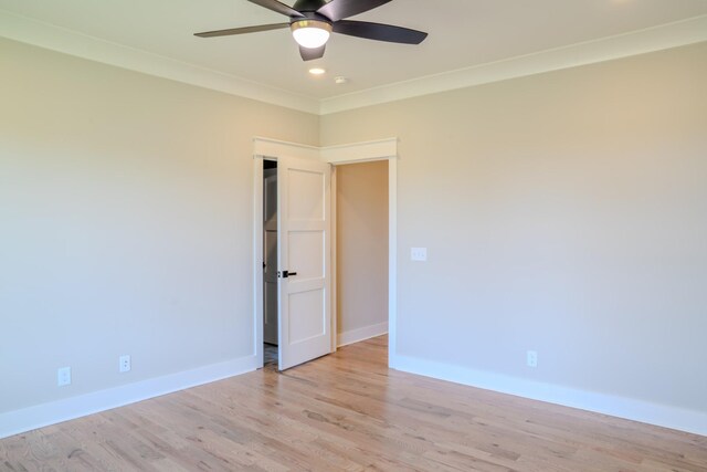 empty room featuring ceiling fan, ornamental molding, and light hardwood / wood-style flooring