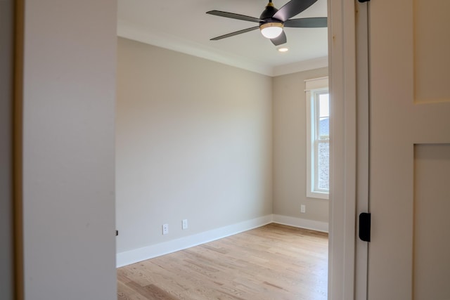 empty room with ceiling fan, light hardwood / wood-style flooring, plenty of natural light, and ornamental molding