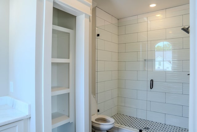 bathroom featuring toilet, built in features, and walk in shower