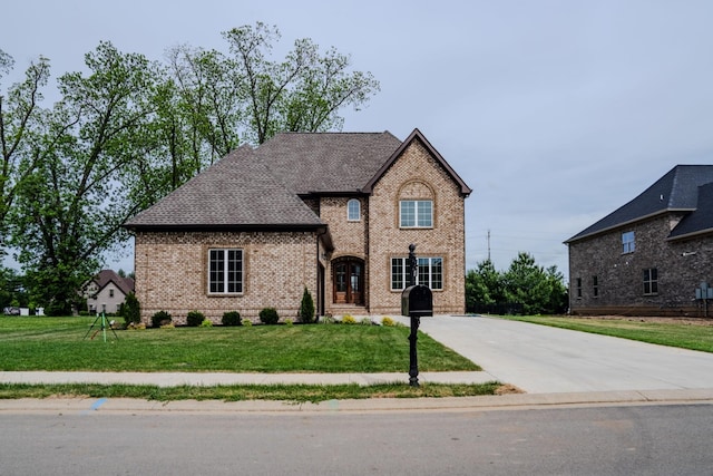 french provincial home featuring a front yard