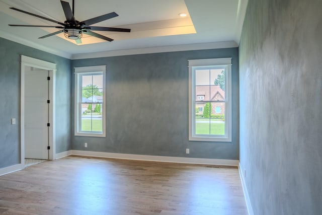 empty room featuring ceiling fan, ornamental molding, and light hardwood / wood-style flooring