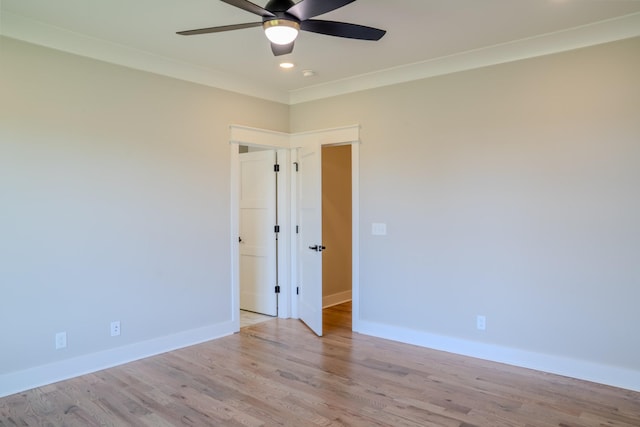 spare room with light hardwood / wood-style flooring, ceiling fan, and ornamental molding