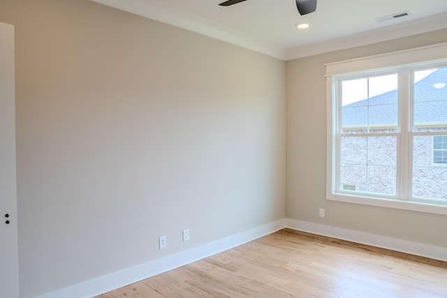 unfurnished room featuring ceiling fan, light wood-type flooring, and ornamental molding