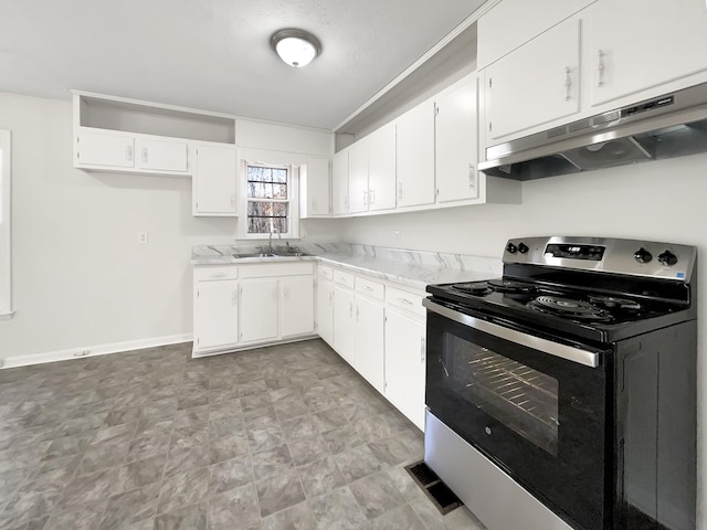 kitchen with white cabinets, light stone countertops, electric stove, and sink