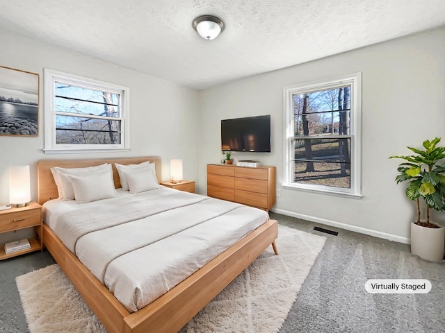 bedroom with multiple windows and a textured ceiling