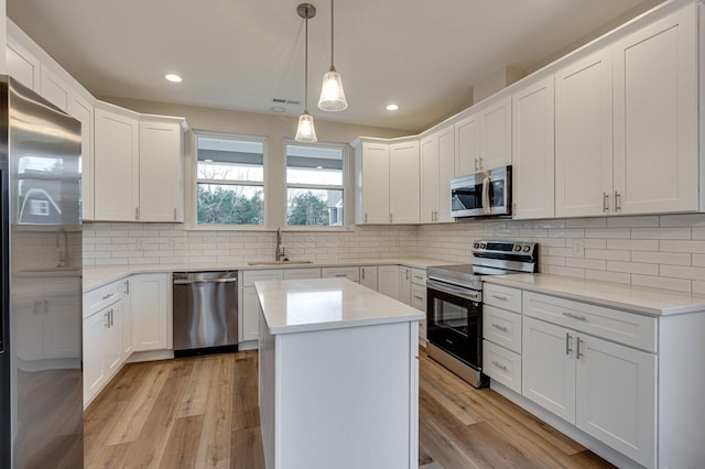 kitchen featuring white cabinets and appliances with stainless steel finishes