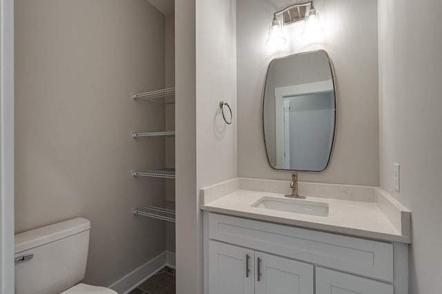 bathroom featuring tile patterned flooring, vanity, and toilet