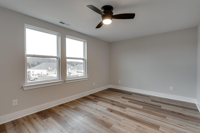 empty room featuring ceiling fan and light hardwood / wood-style flooring