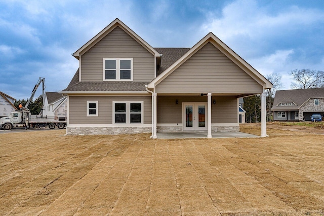 view of front of home featuring a patio area, french doors, and a front yard