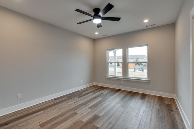 empty room featuring light wood-type flooring and ceiling fan