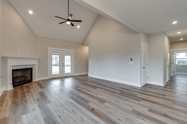 unfurnished living room featuring ceiling fan, light hardwood / wood-style floors, and french doors