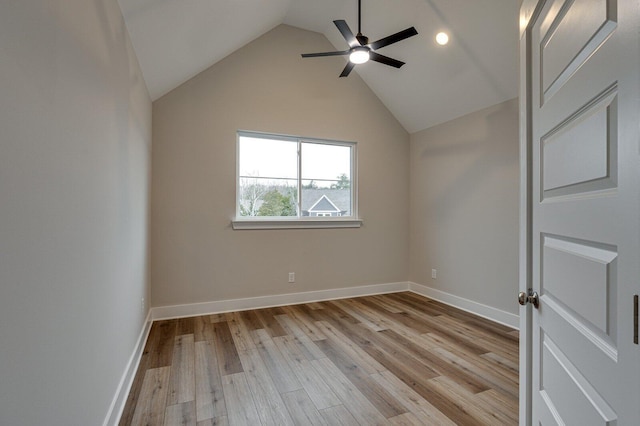 empty room featuring light hardwood / wood-style flooring, ceiling fan, and lofted ceiling