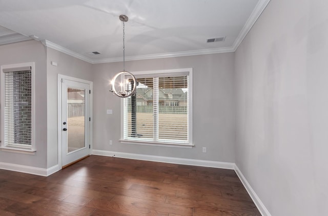 unfurnished dining area with dark hardwood / wood-style flooring, crown molding, and a chandelier