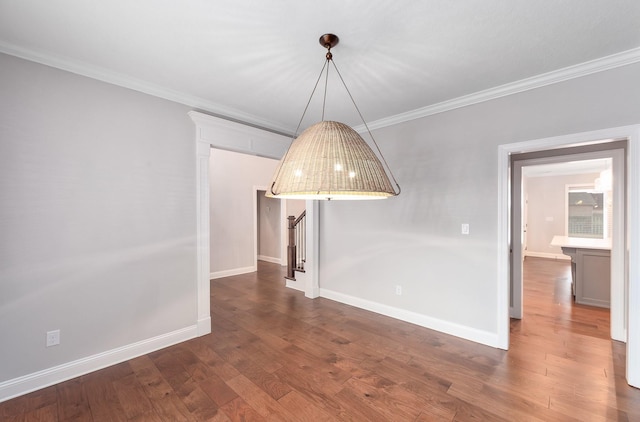 unfurnished dining area featuring ornamental molding and dark hardwood / wood-style floors