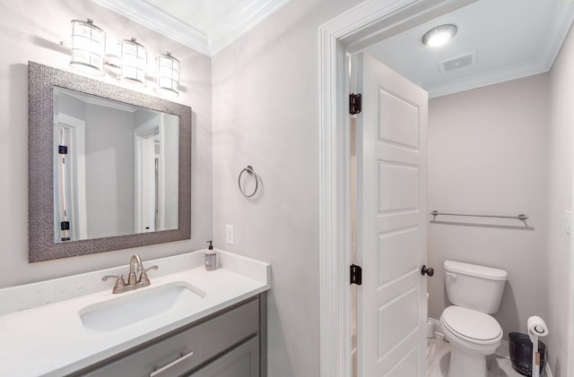 bathroom featuring ornamental molding, vanity, and toilet