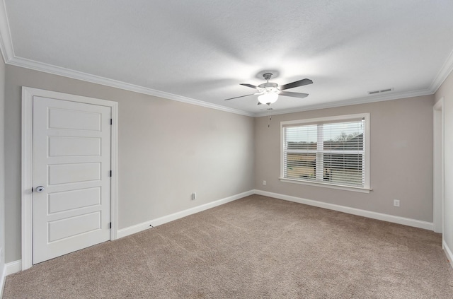 empty room featuring carpet floors, ornamental molding, and ceiling fan