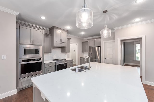 kitchen featuring pendant lighting, sink, stainless steel appliances, tasteful backsplash, and dark hardwood / wood-style flooring