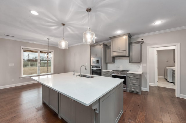 kitchen with stainless steel appliances, sink, pendant lighting, and gray cabinets