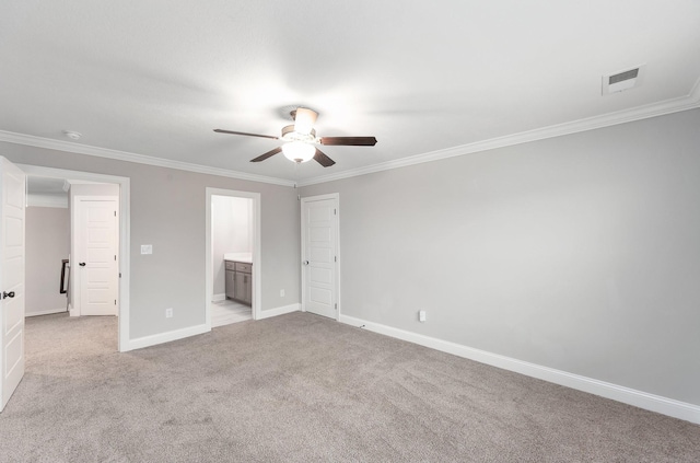 unfurnished bedroom featuring ceiling fan, ornamental molding, connected bathroom, and light colored carpet