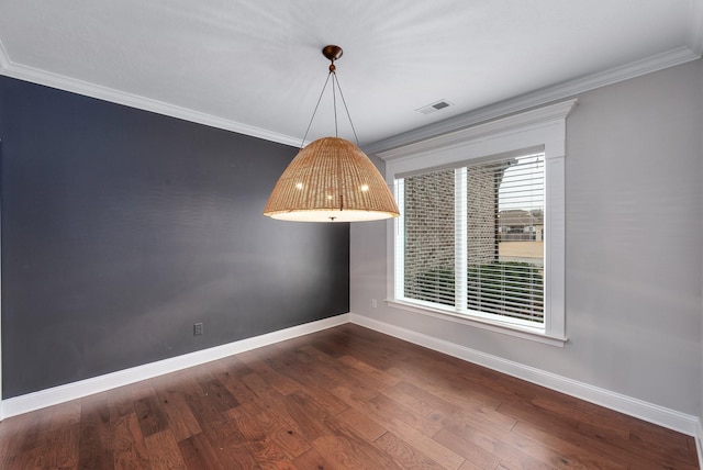 unfurnished dining area featuring crown molding and dark hardwood / wood-style floors