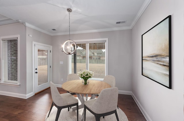 dining space with crown molding, an inviting chandelier, and dark hardwood / wood-style flooring