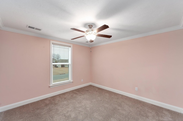 empty room featuring ornamental molding, carpet floors, and ceiling fan