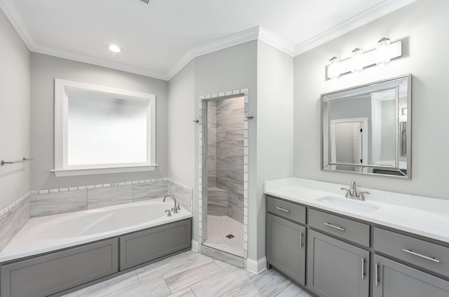 bathroom featuring ornamental molding, shower with separate bathtub, and vanity