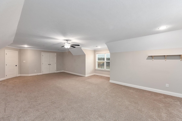 additional living space featuring light carpet and ceiling fan