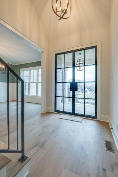 entryway featuring a chandelier and light hardwood / wood-style floors