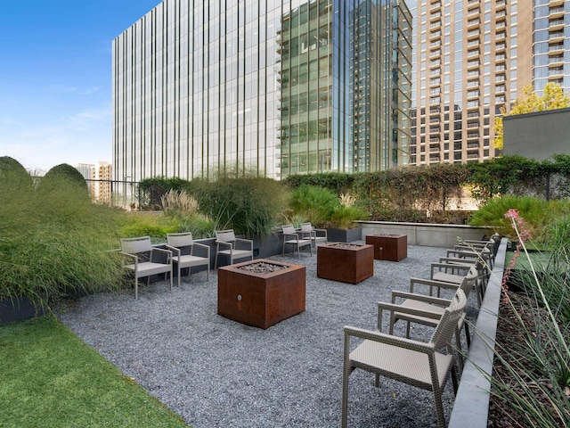 view of property's community featuring a patio area and an outdoor fire pit