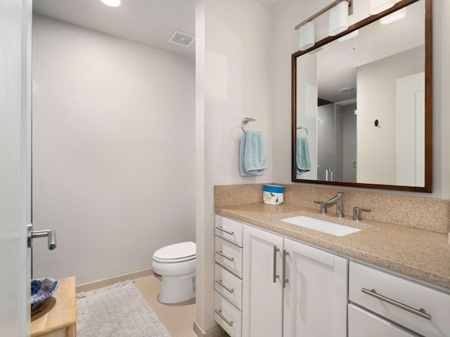 bathroom with tile patterned floors, vanity, and toilet